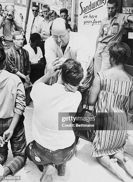 Robert Fehsenfeldt, owner of the Dizzyland Restaurant, smashes an egg in a white demonstrator's face here July 8 during an eleven person, fifteen...