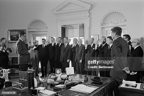 President Kennedy watches as Herbert Miller administers the oath to the members of the General Advisory Committee of the Arms Control and Disarmament...
