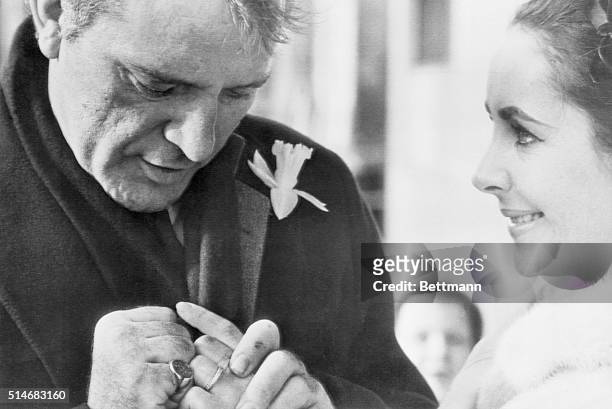 Toronto, Canada: Richard Burton and Elizabeth Taylor display thier wedding rings for Toronto photographer. Married in a secret ceremony in Montreal,...