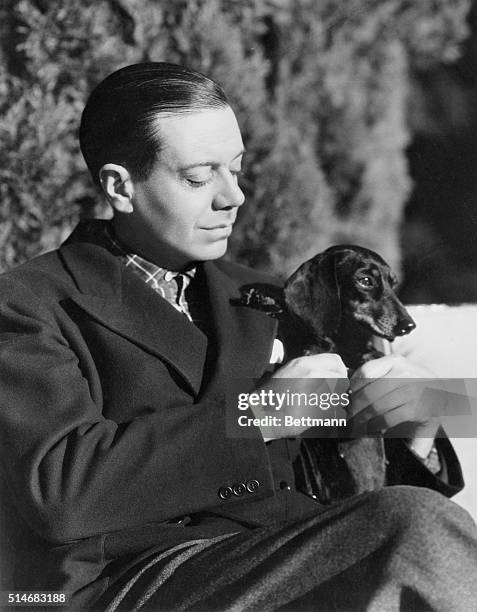 Composer Cole Porter, portrait, with his dog.