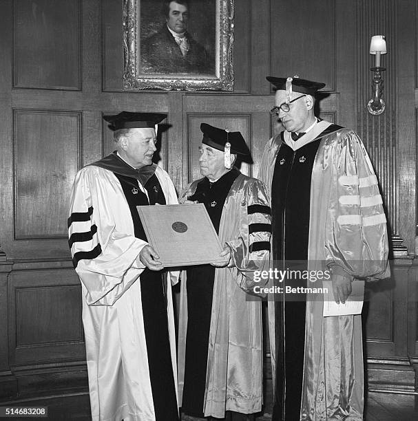 Finnish architect Alvar Aalto receives an honorary degree from Dr. Grayson Kirk, President of Columbia University. Standing next to them is Kenneth...