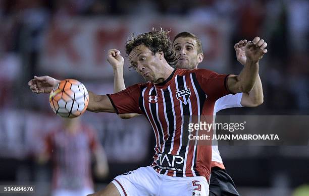 Brazil's Sao Paulo defender Diego Lugano vies for the ball with Argentina's River Plate forward Ivan Alonso during their Libertadores Cup group 1...