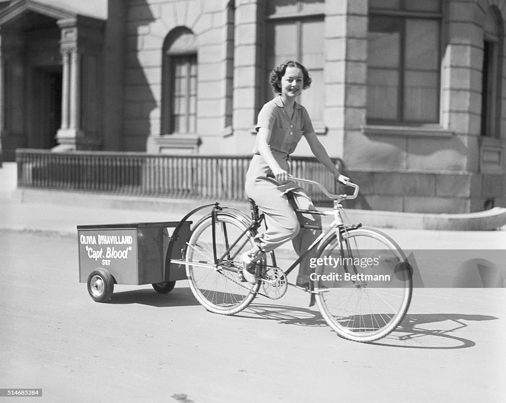 Olivia De Havilland Riding Bicycle