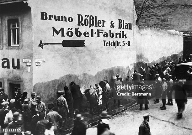 Jews have been rounded up and forced to whitewash a wall by Nazi S.A. Brownshirts in the city of Chemnitz, Saxony. Germany, 1933.