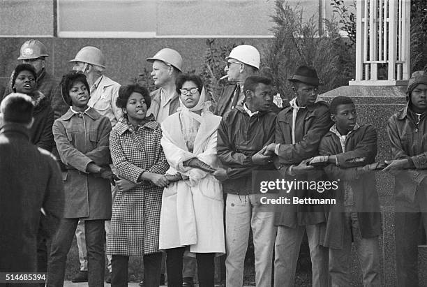 Civil rights demonstrators link hands and sing during a protest at the Dallas Country Courthouse in Selma, Alabama. Later, Sheriff Jim Clark ordered...