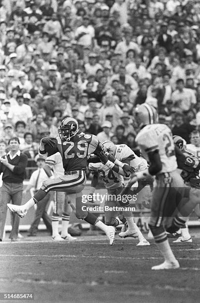 Los Angeles Rams running back Eric Dickerson escapes the grasp of Dallas Cowboys free safety Michael Downs and runs for a forty yard touchdown in the...