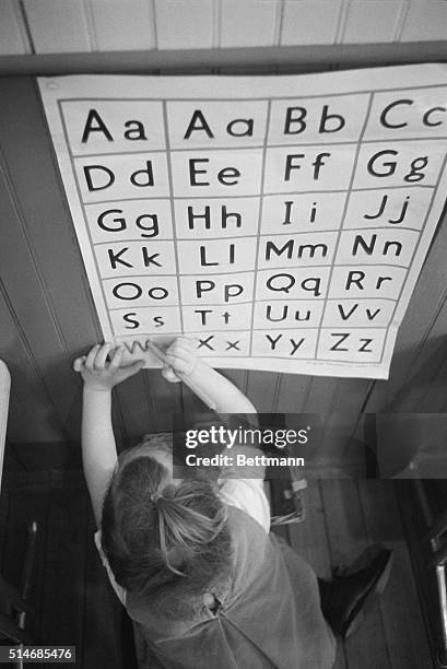 Preschooler learns through an educational method introduced by Dr. Maria Montessori in Italy during the early 1900s.