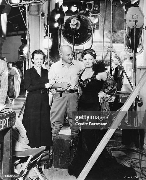 Director Cecil B. DeMille stands with his two daughters, Kathryn and Agnes, on the set of his film Cleopatra. Agnes DeMille will play a dancer in the...