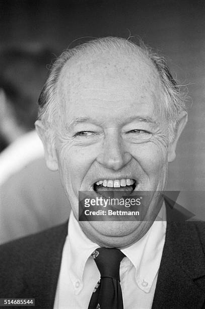 Convicted Watergate burglar E. Howard Hunt laughs outside a court house in Miami during his libel trial against a right wing magazine.
