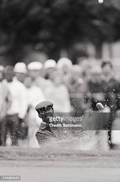 Golfer Calvin Peete hits his ball out of the sand trap on the fourth hole during the first round of the 1986 U.S. Open golf tournament. Southampton,...