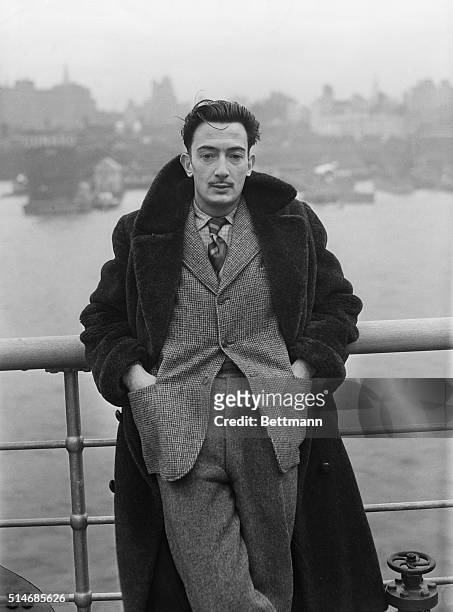 Surrealist Salvador Dali stands on the deck of the S.S. Normandie as it docks in New York City.