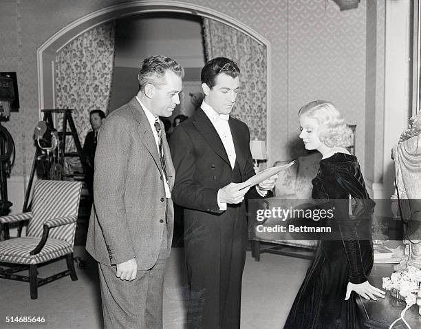 Jean Harlow and Robert Taylor stand with W.S. Van Dyke, who is the director of The Man in Possession, the film in which they co-star.