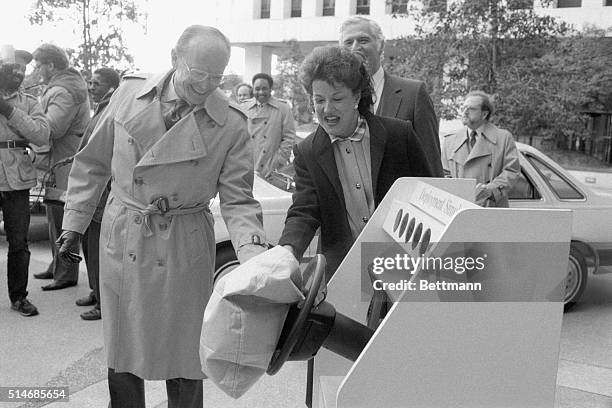 Transportation Secretary Elizabeth Dole and Ford Motor Company Chairman Donald Petersen watch a demonstration of air bags to be installed in the...