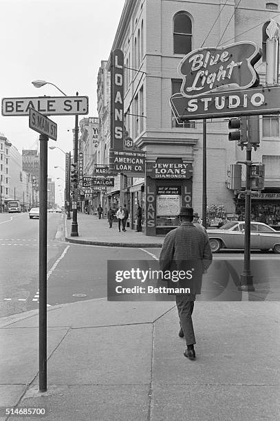 Pedestrian on Beale Street, the legendary birthplace of the blues and center of jazz music, Memphis, Tennessee. The street is lined with pawn shops...