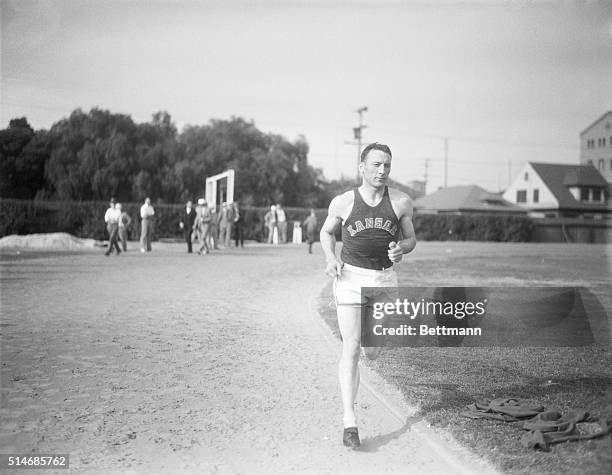 Miler Glenn Cunningham of the University of Kansas runs around the track at Bovard Field in preparation for the NCAA meet at the Los Angeles Coliseum...