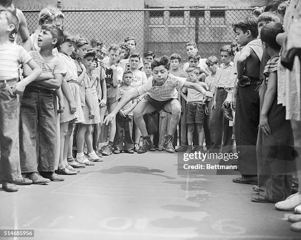 New York: Joseph Liso of 171 Thompson St., does the standing broad jump during competitions atthe second annual Children's Aid Society Olympics held...