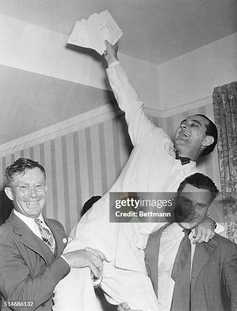 Austin, Texas: Rep. Lyndon Johnson rides on the shoulders of a pair of stalwart campaign workers in his hotel room where he and friends are listening...