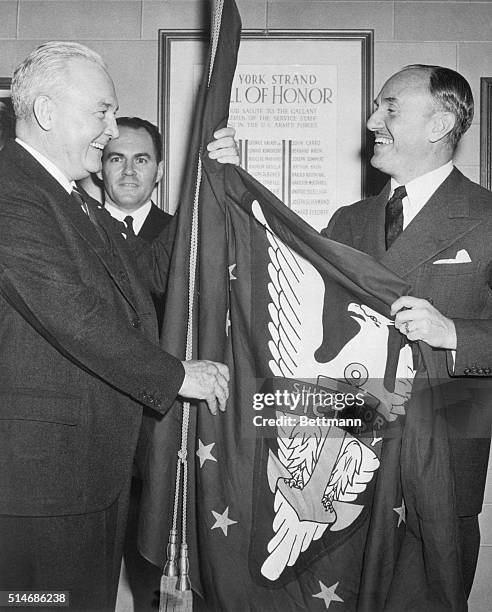 New York City: Captain Edward MacAuley , Deputy Administor of the War Shipping Administration, presents the first victory flag to be awarded a motion...