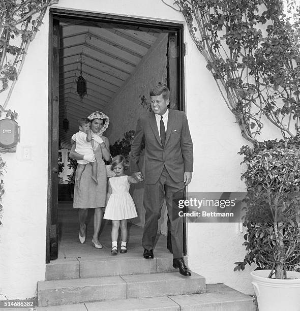 President John F. Kennedy walks with the First lady and their children, John, Jr., and Caroline. They attended a private Mass at the vacation White...