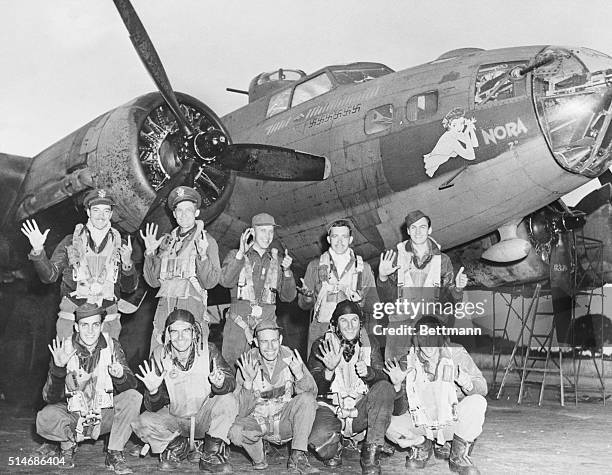 The crew of the flying fortress Nora hold up six fingers to tell how many German planes they have shot down. The NoraBoeing B-17 Flying Fortress.