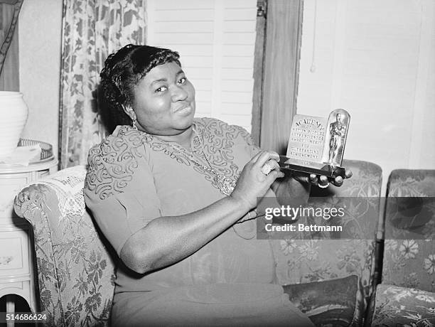 Los Angeles, CA: Actress Hattie Mc Daniel is shown with the statuette she received for her portrayal in "Gone With The Wind." The award was for Best...