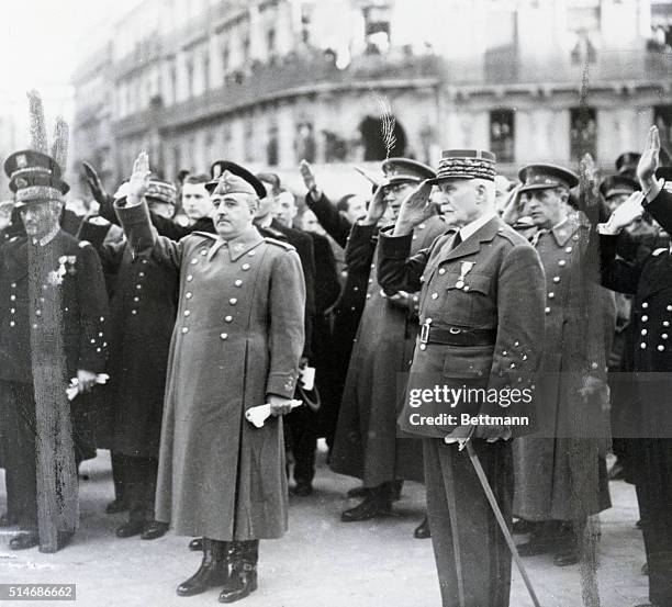 Spanish dictator Francisco Franco and Henri Petain, head of state for Vichy France, salute during the French national anthem during a meeting in...