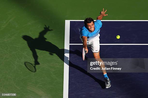 Taylor Fritz of USA stretches for a forehand against Frances Tiafoe of USA during day four of the BNP Paribas Open at Indian Wells Tennis Garden on...