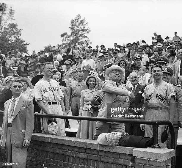 President Truman throws out the first ball at the annual Army-Navy baseball game at the Navy Academy here today. On the left is Andrew Frahler, Navy...