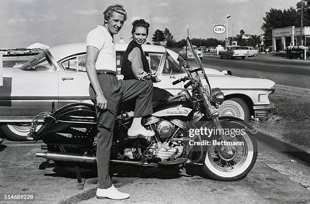 Memphis, Tennessee: Rock 'n' roll singer Jerry Lee Lewis and his 13-year-old wife, Myra, get set for a motorcycle ride here, June 14th, after the...