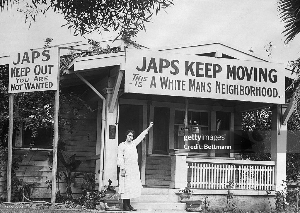Homeowner Pointing to Anti-Japanese Sign