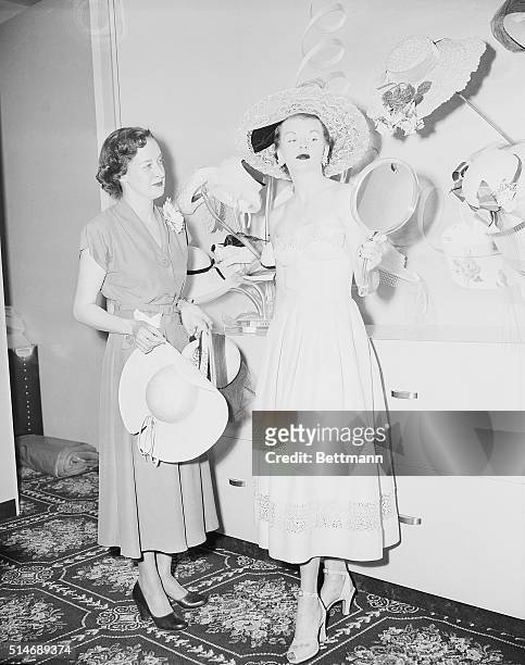 New York, NY: Trying on hats at the new Bloomingdale's store in Fresh Meadow, Queens. Mrs. Paula Paine of 189-02 64th Ave, Flushing Meadows tries on...
