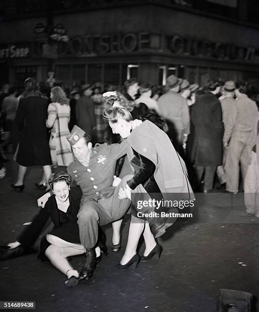 New York, NY: Elated trio fall to the ground on V-E Day, New York.