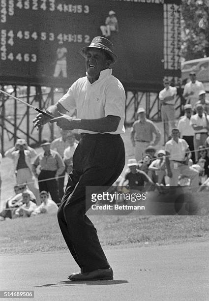 Open leader Tommy Bolt cries with delight as he drops in a birdie putt on the 9th green during third round play of the 1958 US Open Championship....