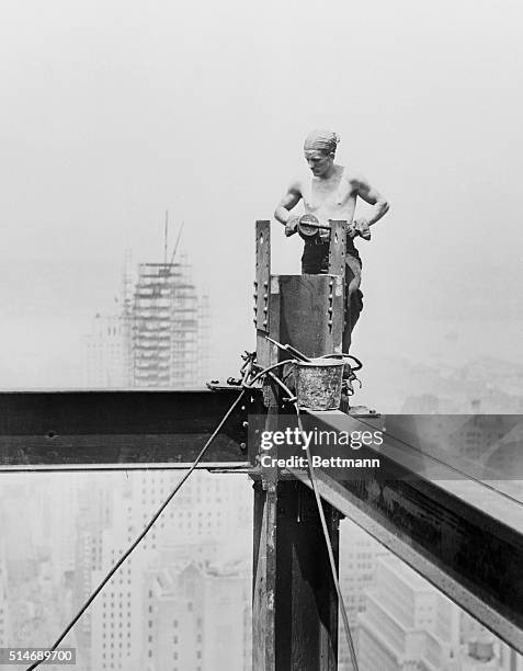 New York: Flirting with danger is just routine work for the steel workers arranging the steel frame for the Empire State Building, which will be the...