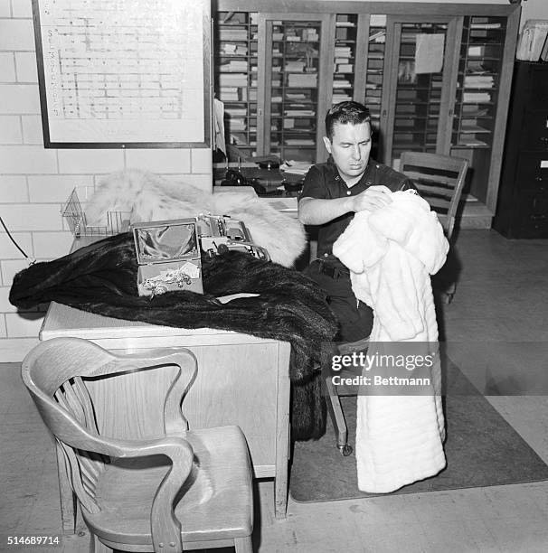 Marilyn Monroe's furs and jewelry shown in police safekeeping after her death. Photograph, 8/7/1962.