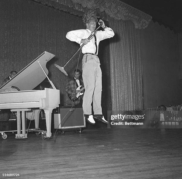 New York: His prodigious head of hair standing on end, rock 'n' roll roller Jerry Lee Lewis hugs the microphone as he does a flying leap during his...