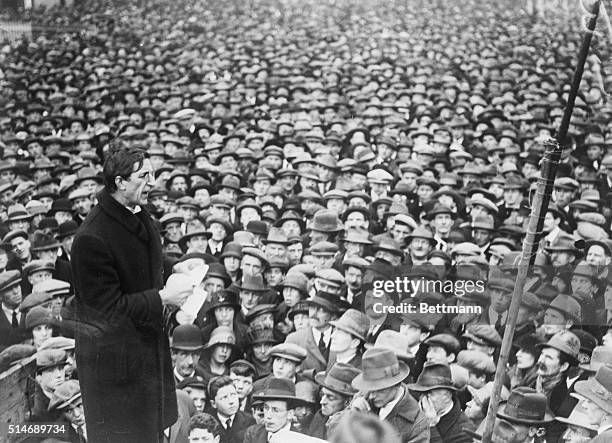 Irish revolutionary leader Eamon de Valera, reading from notes, addresses a huge crowd of Dubliners during his years as Prime Minister of Ireland. De...