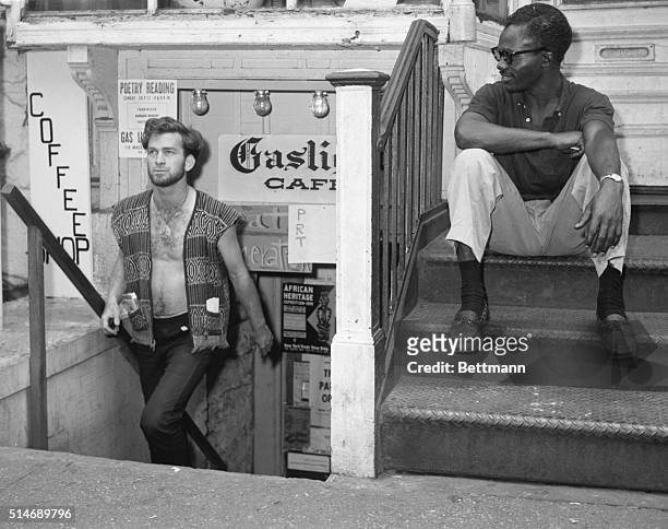 New York, NY: In the world of the beatnik, Dick Woods walks up the steps of the Gaslight Coffee Shop in New York's Greenwich Village. Long a setting...