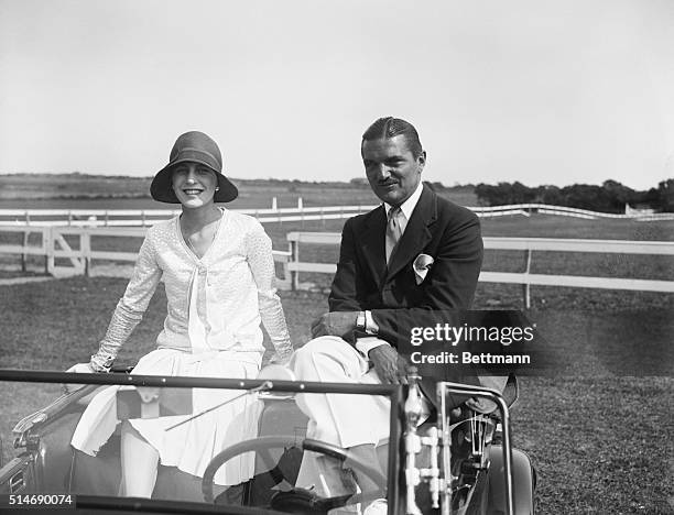 East Hampton, L.I., NY: Mr and mrs. J. Vernon Bouvier 3d, enjoying a convinient view of the fifth annual show of the Easthampton Riding Club, from...