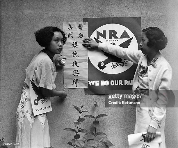San Francisco, California: Constance King and Mae Chinn, of the Chinese Y.M.C.A., San Francisco, shown with the N.R.A. Signs which they are pasting...