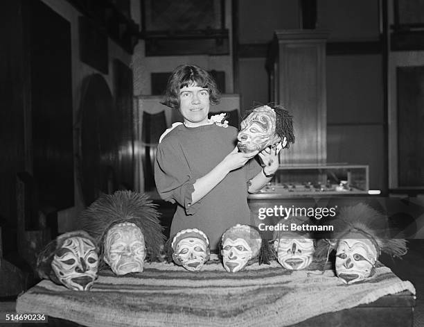Dr. Margaret Mead, Assistant Curator of Ethnology at the American Museum of Natural History, displays some of the trophy heads that she brought back...