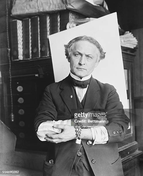 Houdini showing how to slip handcuffs.