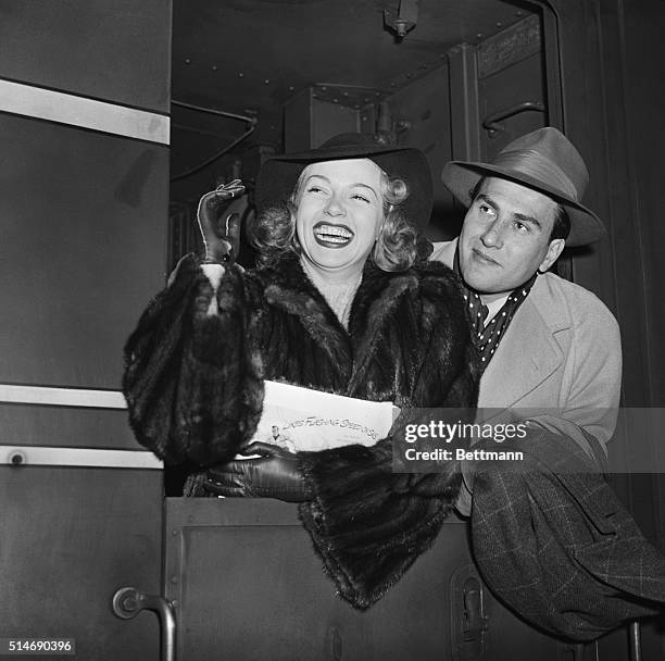 New York: Artie Shaw, the orchestra leader who hitched his wagon to a star, is shown with that star, his bride, Lana Turner, as they waved a hello to...