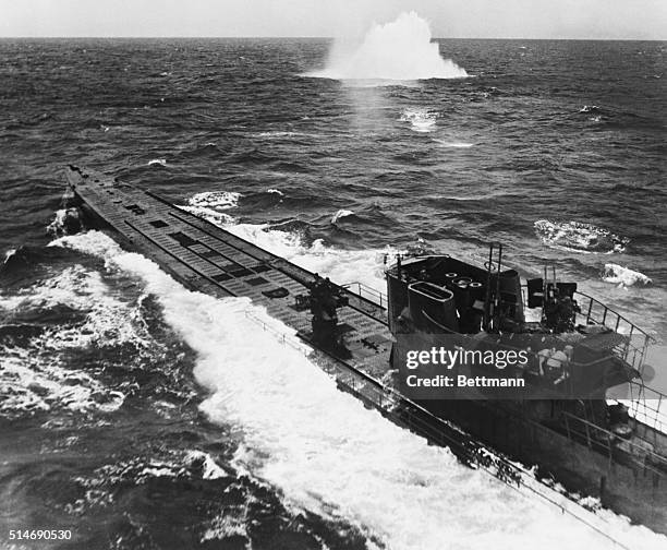 Surfaced German U-boat is under attack by American B-25 Mitchell and B-24 Liberator bombers. A few minutes after this photograph was taken, the...