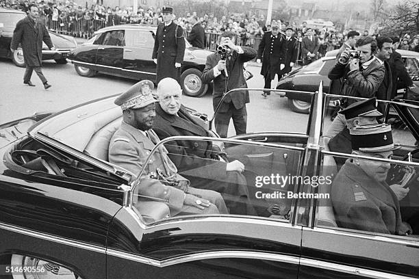 Paris, France: General Jean Bedel Bokassa, Central African President, riding in open car with de Gaulle from railway station in Paris.