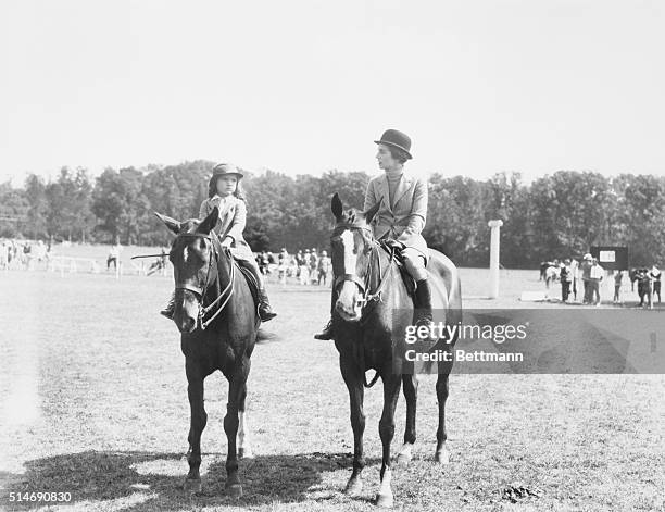 Smithtown, Long Island: Mrs. John Bouvier 3rd, society equestrienne, is pictured with her daughter, Jacqueline in the parent and child class of the...
