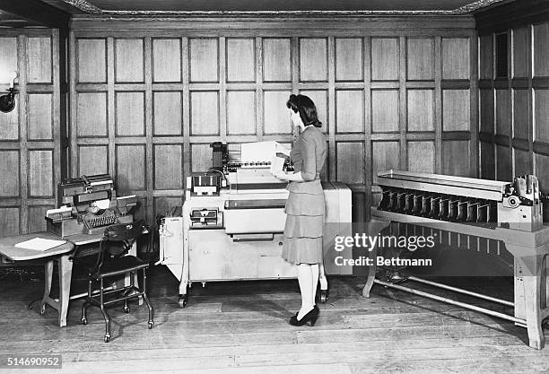 Secretary Punch Card operator with equipment used in the 1940's. Photograph.