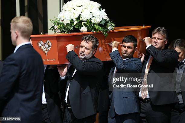 The pall bearers including actor and cousin Russell Crowe carry the casket after the funeral service for Martin Crowe on March 11, 2016 in Auckland,...