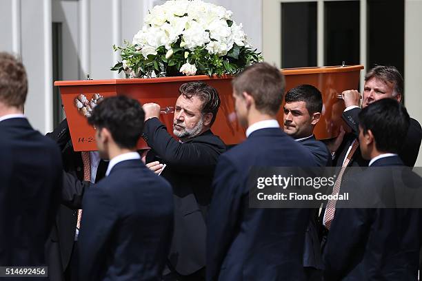 The pall bearers including actor and cousin Russell Crowe carry the casket after the funeral service for Martin Crowe on March 11, 2016 in Auckland,...