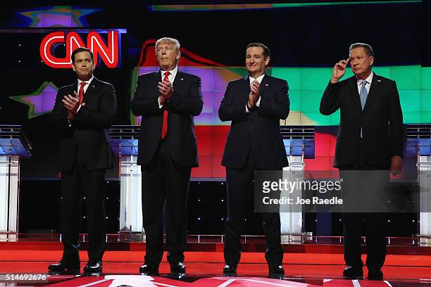 Republican presidential candidates, Sen. Marco Rubio , Donald Trump, Sen. Ted Cruz , and Ohio Gov. John Kasich applaud after the performance of the...